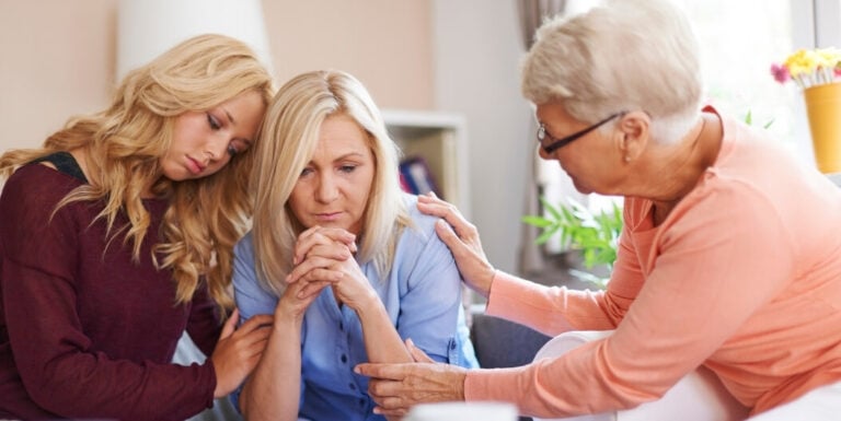 Elderly Woman Providing Emotional Support to Family Members at an Assisted Living Facility